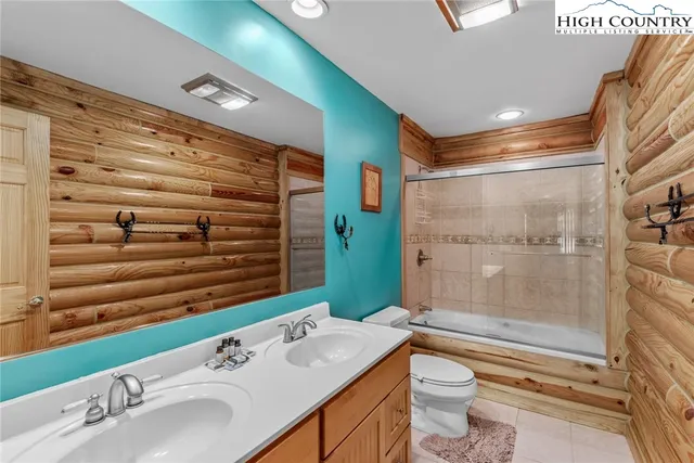 a room with pool table and windows