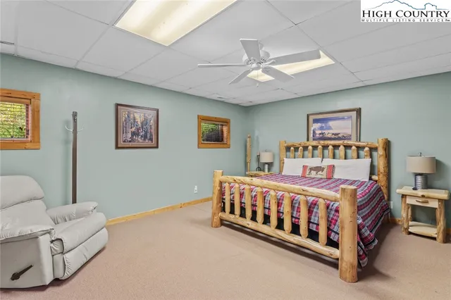 a bedroom with a bed and flat screen tv