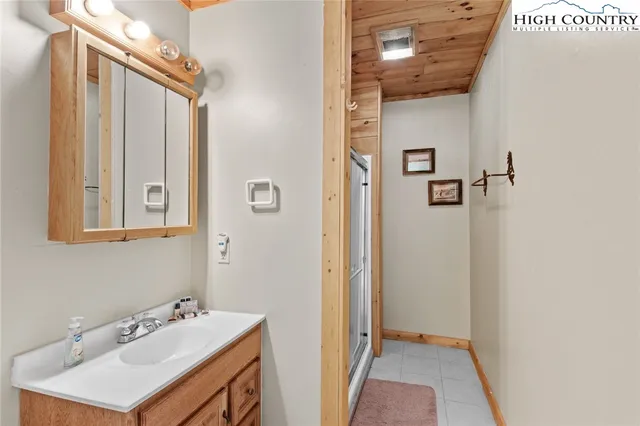 a view of an empty room with wooden floor and furniture