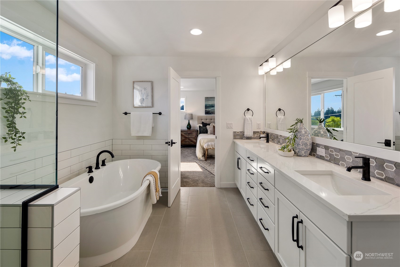 3920 211th Place Southeast Bothell, WA 98021 - Photo 17 of 26 a large white bathroom with a double vanity sink a mirror and a bathtub