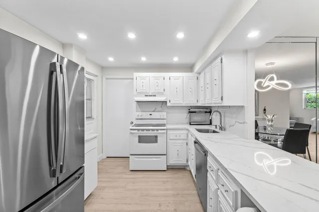 a kitchen with a sink stainless steel appliances and cabinets