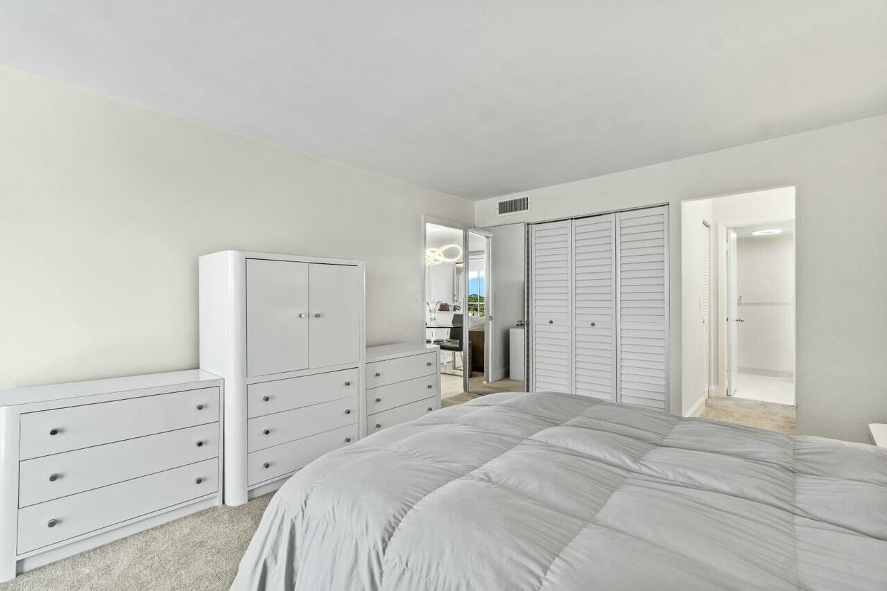6461 Northwest 2nd Avenue, Unit 411 Boca Raton, FL 33487 - Photo 14 of 34 a bedroom with a bed and a dresser