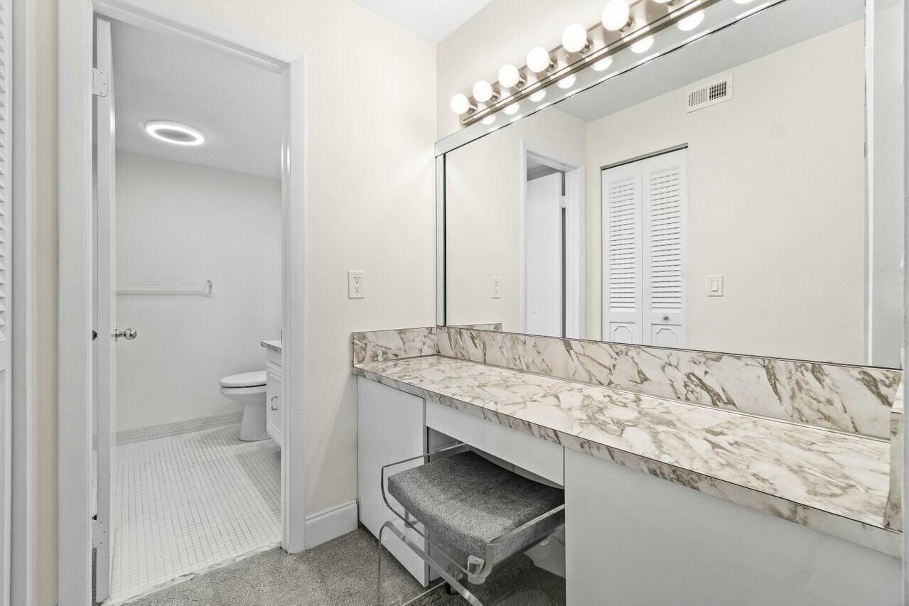6461 Northwest 2nd Avenue, Unit 411 Boca Raton, FL 33487 - Photo 15 of 34 a bathroom with a sink and a mirror