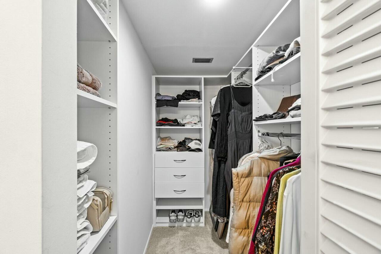6461 Northwest 2nd Avenue, Unit 411 Boca Raton, FL 33487 - Photo 18 of 34 a view of walk in closet with clothes and shoes