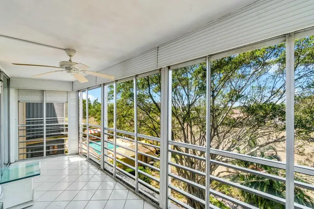 a view of a porch with a floor to ceiling window and stairs