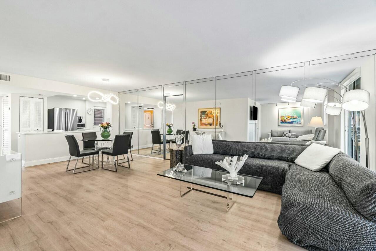 6461 Northwest 2nd Avenue, Unit 411 Boca Raton, FL 33487 - Photo 8 of 34 a living room with furniture and wooden floor