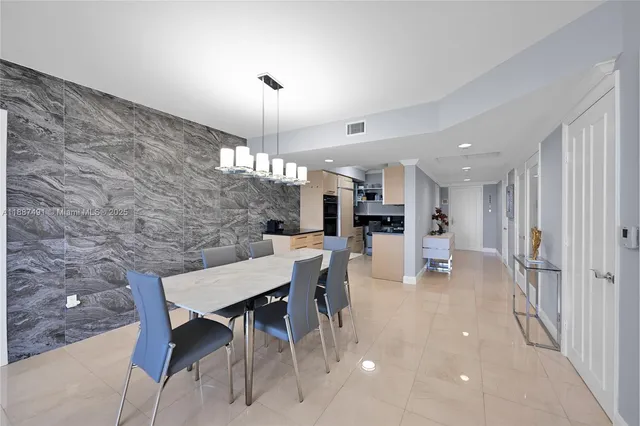 a dining room with furniture and chandelier