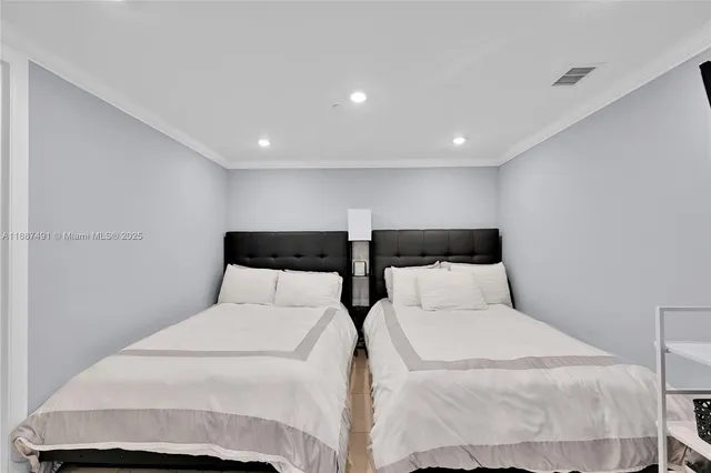 a large white bed in a white room