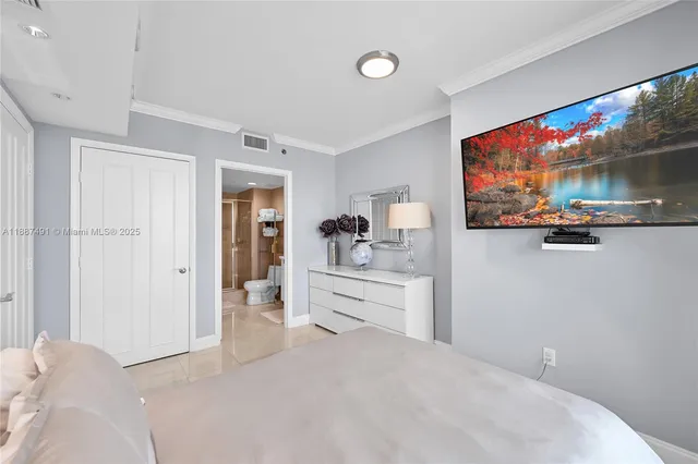 a bedroom with a bed and a flat screen tv