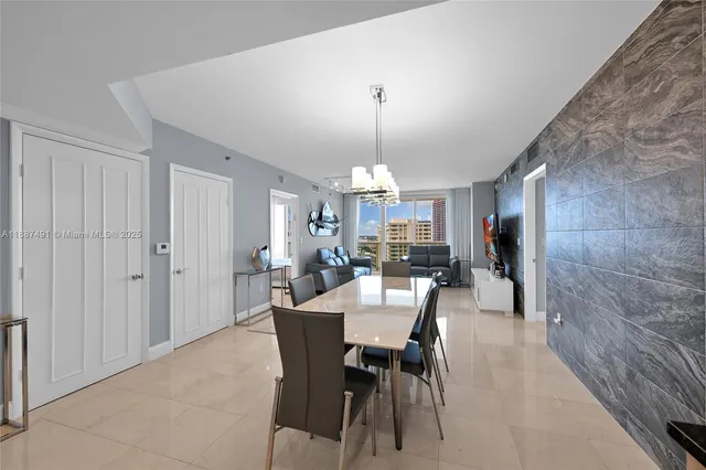 a view of a dining room with furniture and chandelier