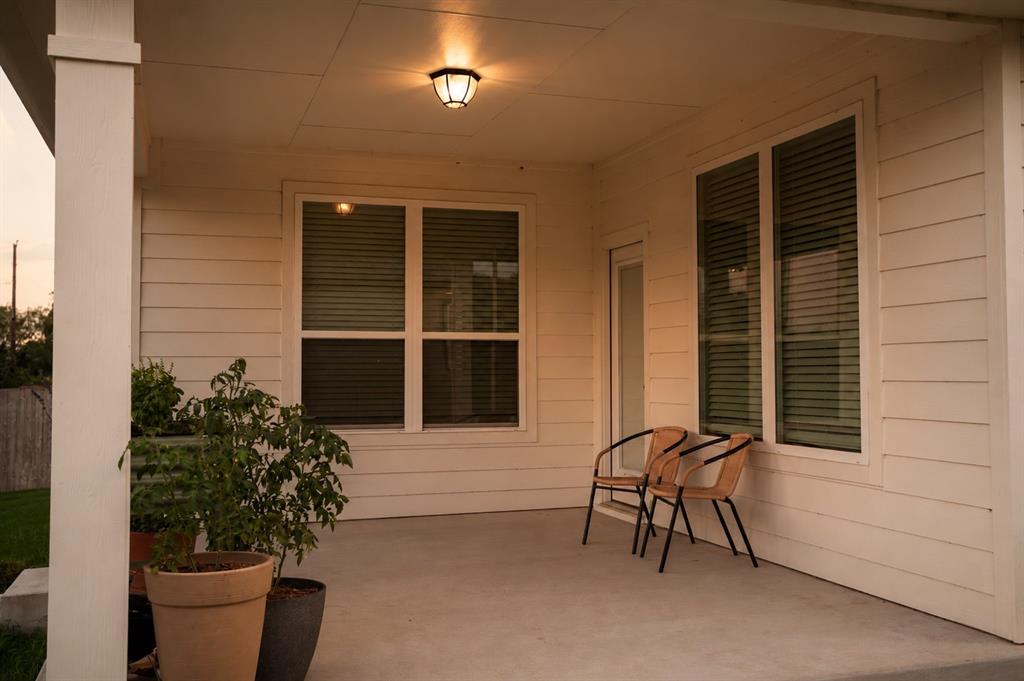 7909 Townsend Drive Waco, TX 76708 - Photo 20 of 22 Covered outdoor patio with a ceiling-mounted light fixture, white siding, and multiple windows