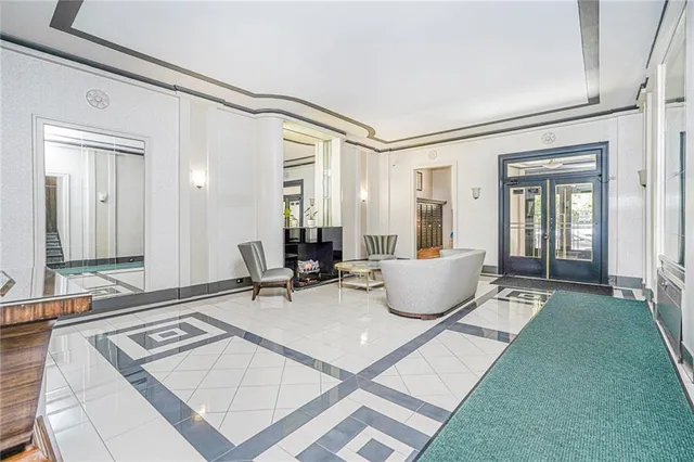 a living room with a couch and a potted plant on table