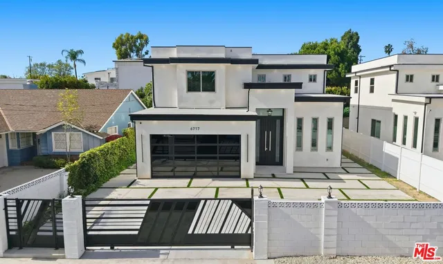 a view of a white house with large windows