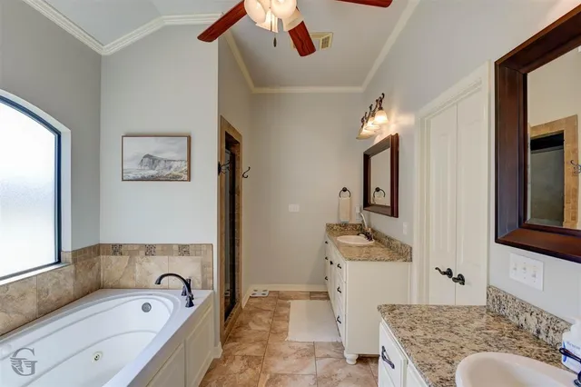 a en suite spacious bathroom with a couch mirror and a bathtub