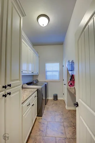 a view of cabinets a washer and dryer