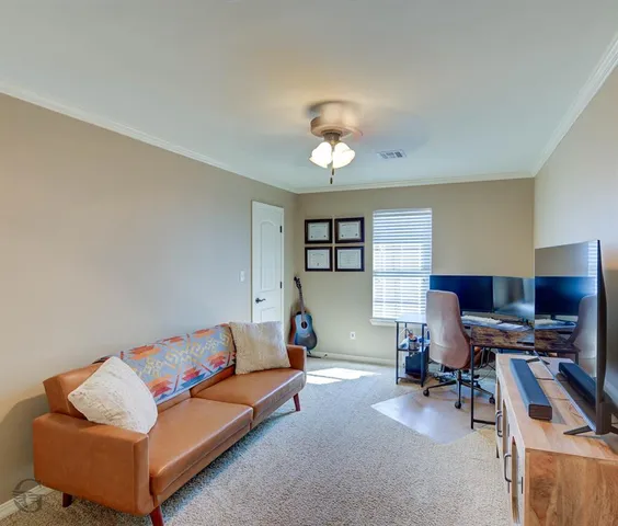 a living room with furniture a piano and a window