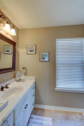 a bathroom with a double vanity sink and a mirror