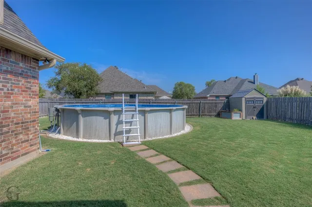 a view of a house with a yard and deck