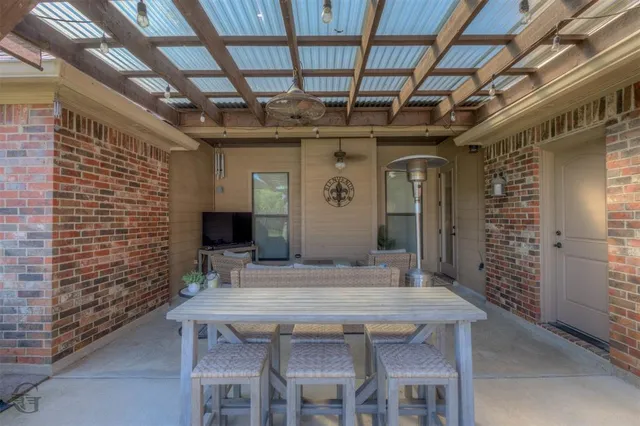a dining room with stainless steel appliances a table and chairs
