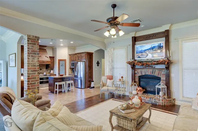 a living room with furniture a fireplace and a chandelier