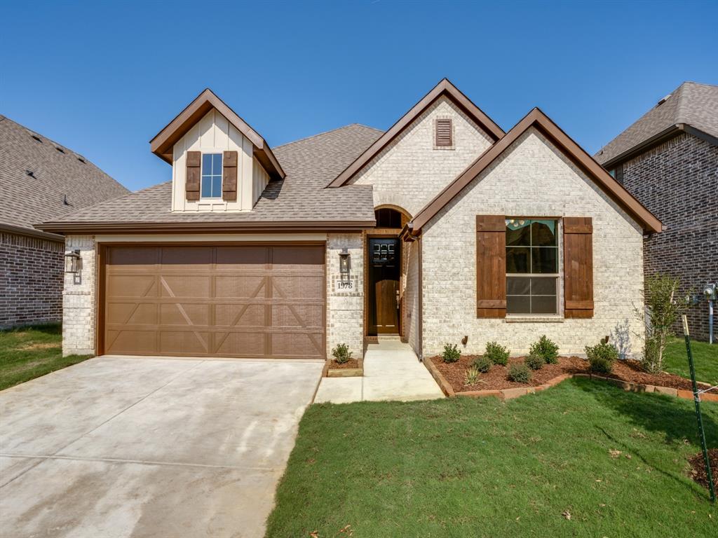 139 Lakeview Circle Pilot Point, TX 76258 - Photo 19 of 19 Example of same Thackery Custom Home floorplan Craftsman-style home featuring a light brick facade, dark wood trim, and a two-car garage