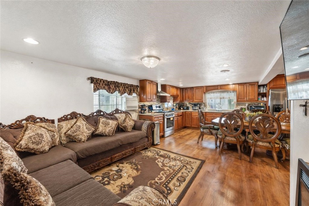 a living room with lots of furniture and view of kitchen