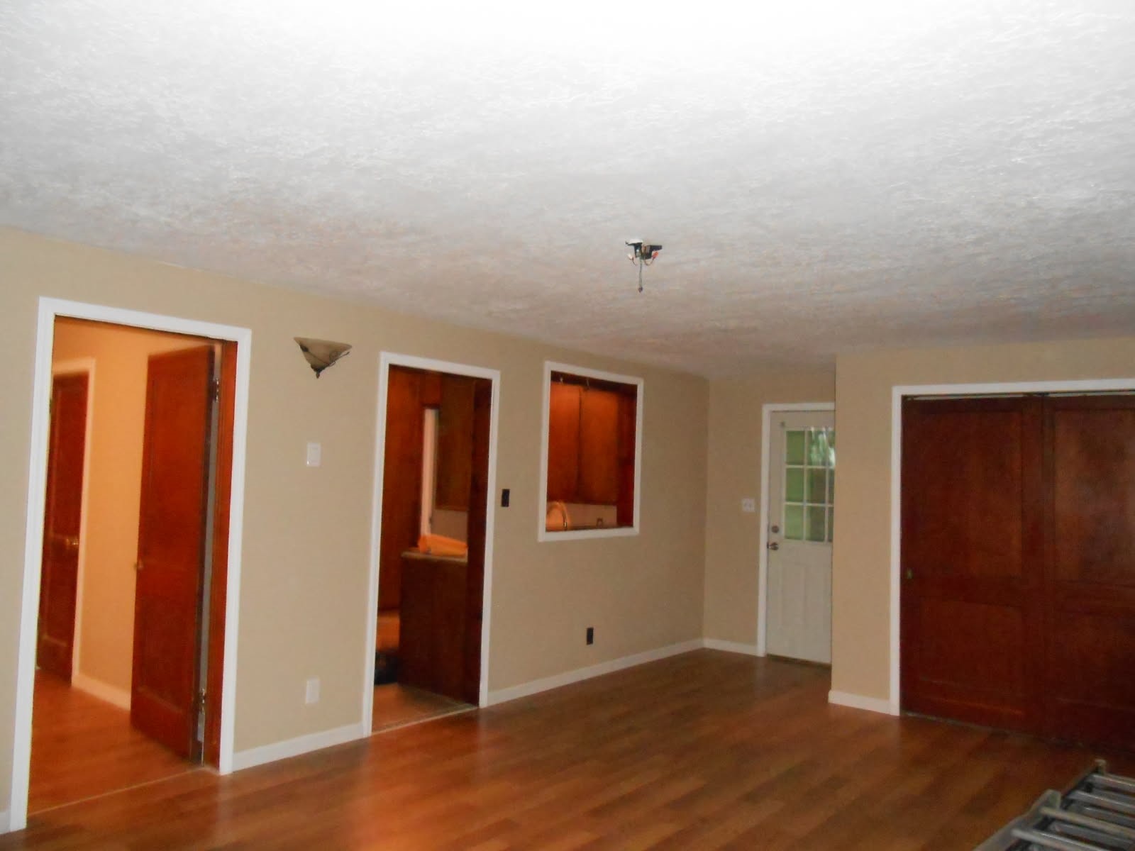 1050 Boyd Street Beaumont, TX 77705 - Photo 3 of 9 an empty room with wooden floor and windows