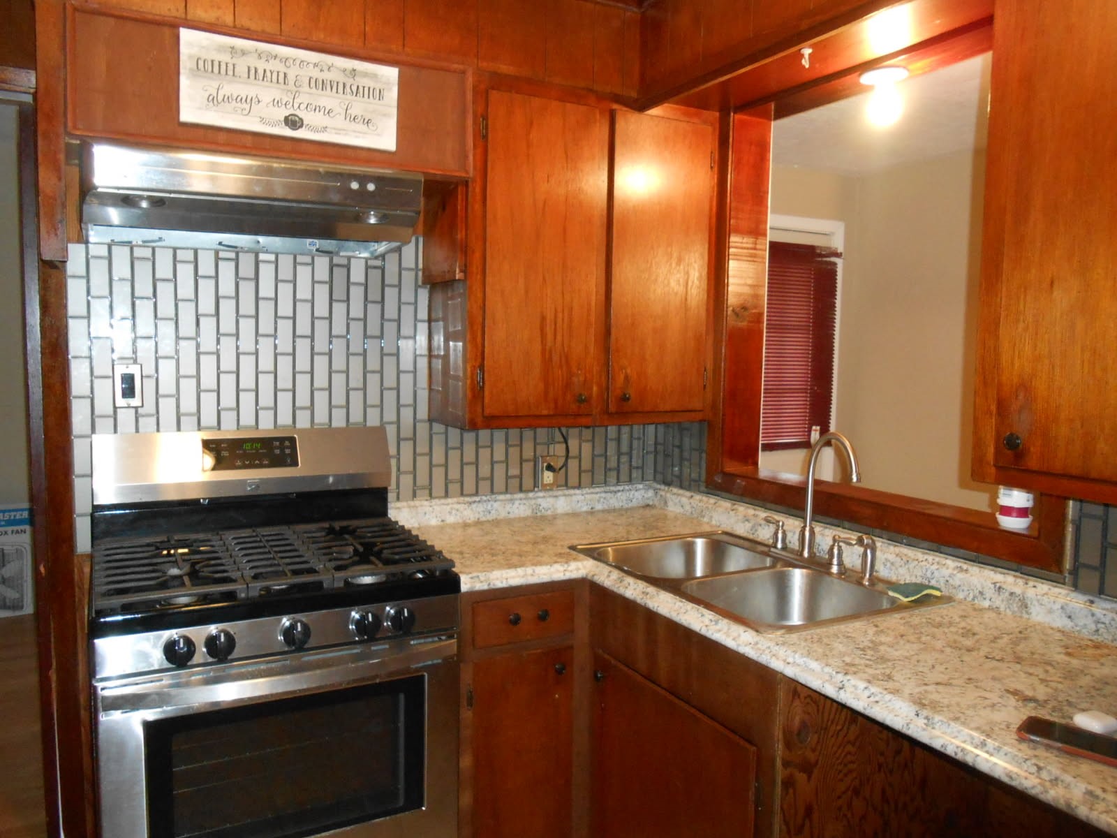 1050 Boyd Street Beaumont, TX 77705 - Photo 5 of 9 a kitchen with a sink stove and cabinets