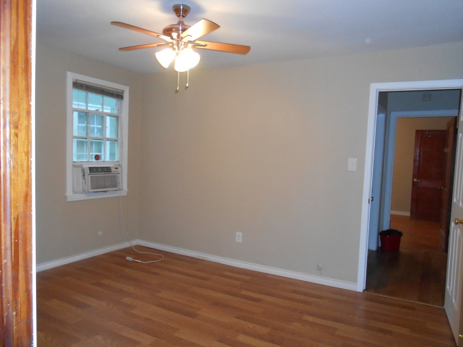 1050 Boyd Street Beaumont, TX 77705 - Photo 7 of 9 wooden floor in an empty room with a window