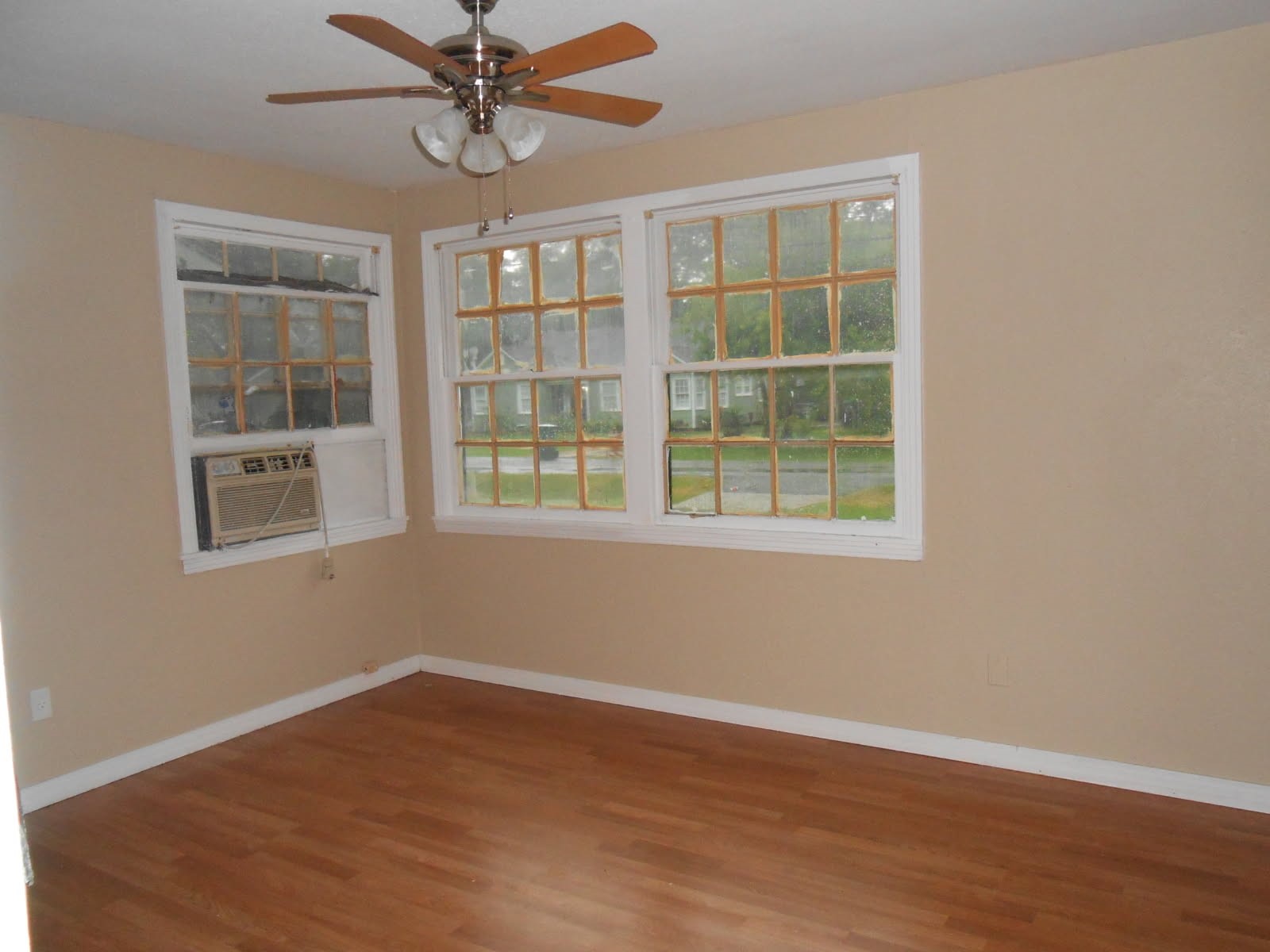 1050 Boyd Street Beaumont, TX 77705 - Photo 8 of 9 a view of an empty room with a window and wooden floor