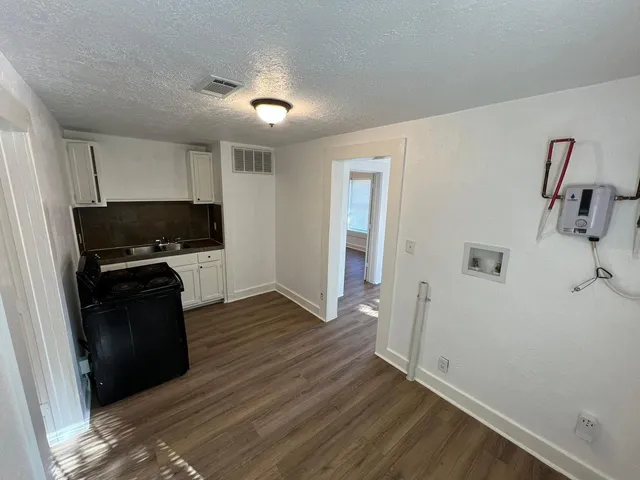 a view of kitchen with wooden floor and electronic appliances