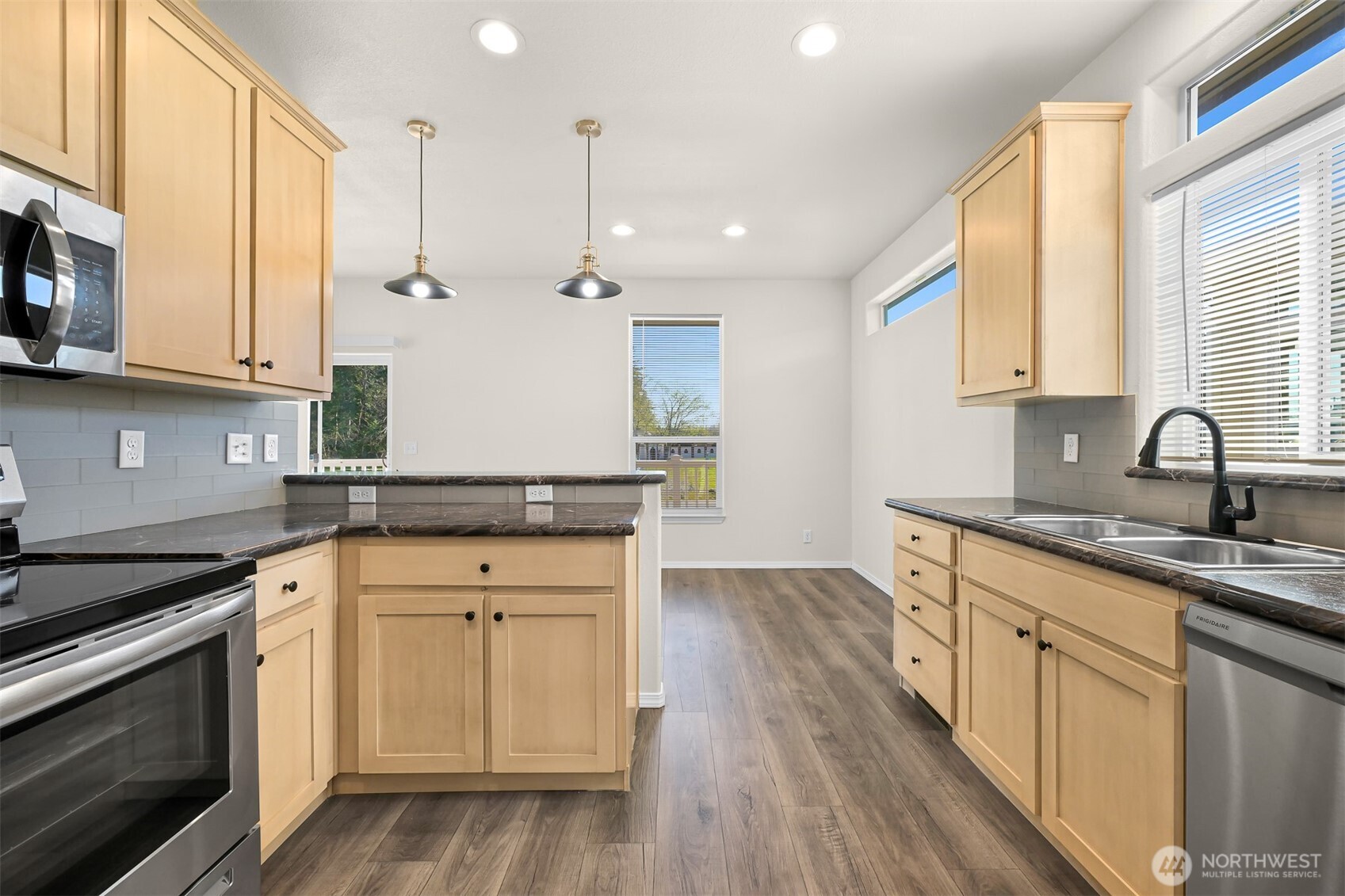 4672 Birch Bay Lynden Road, Unit 90 Blaine, WA 98230 - Photo 3 of 13 a kitchen with sink cabinets and wooden floor