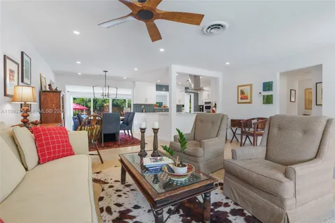 a living room with furniture and kitchen view