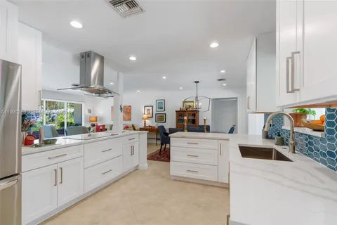 a kitchen with stainless steel appliances kitchen island granite countertop a sink and cabinets