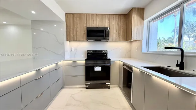 a kitchen with a sink and a stove top oven
