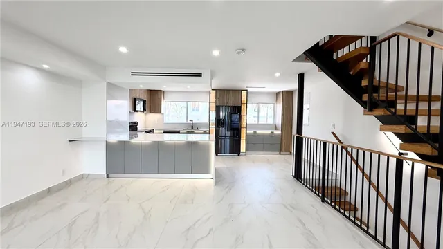 a view of kitchen with cabinets microwave and stove