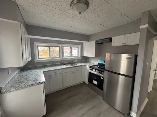 a kitchen with a refrigerator and a sink