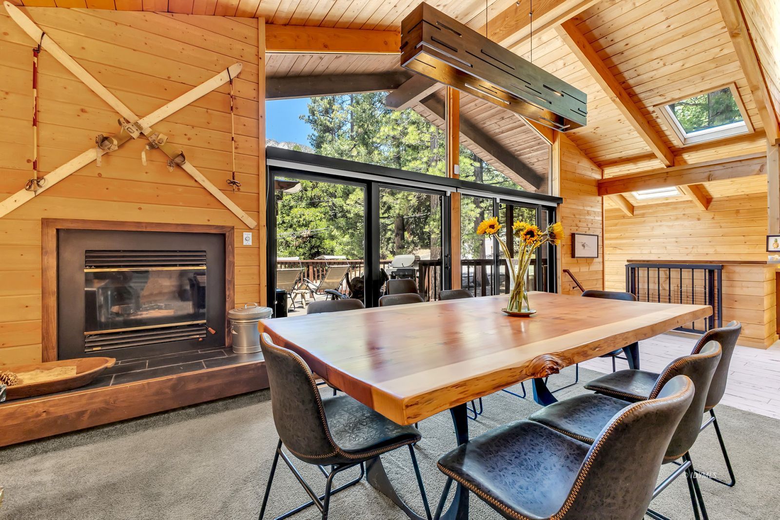 24924 Fern Valley Road Idyllwild, CA 92549 - Photo 23 of 72 a dining room with furniture a fireplace and wooden floor