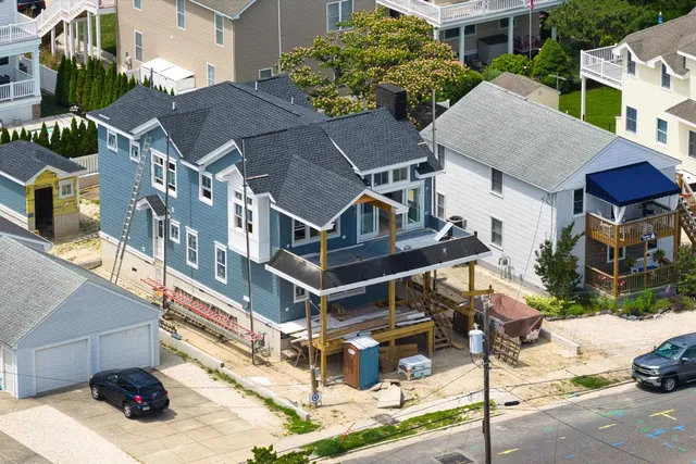a aerial view of a house with a yard and balcony