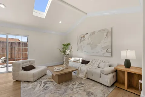 a living room with furniture and a potted plant