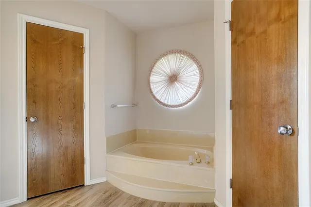 a bathroom with a bathtub and a shower