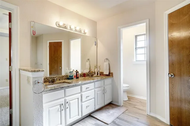 a bathroom with a double vanity sink and a mirror