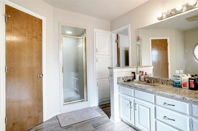 a bathroom with double vanity and a mirror