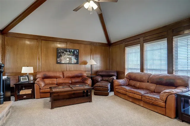 a living room with furniture a couch and a chandelier