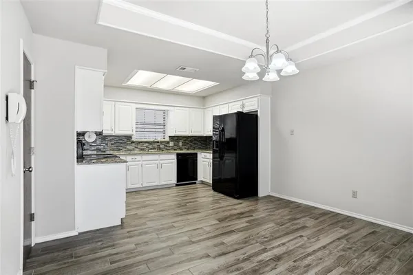 a kitchen with a refrigerator and a stove top oven