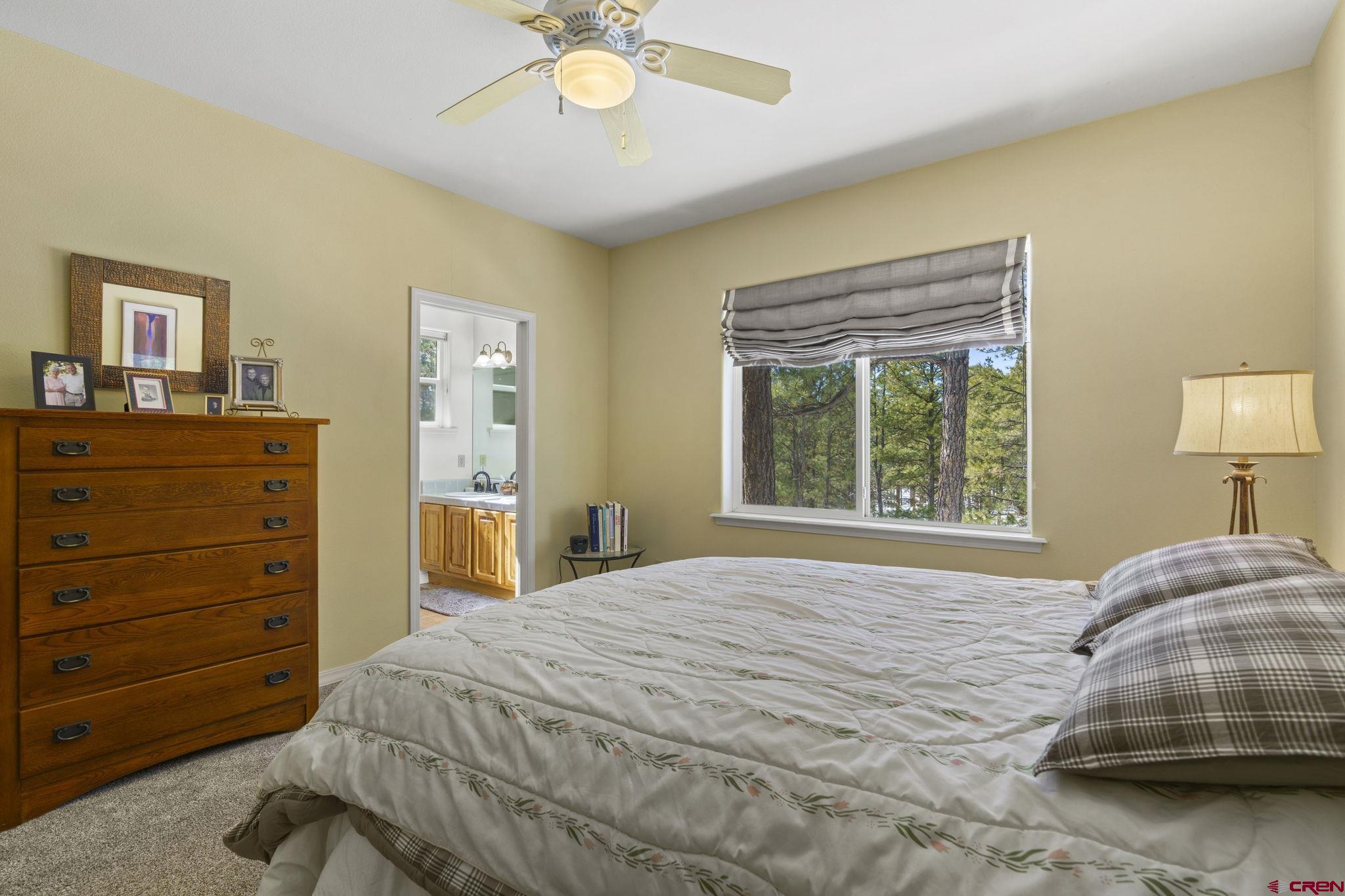 498 Woodbridge Way Durango, CO 81301 - Photo 11 of 26 a bedroom with a bed and a lamp on dresser