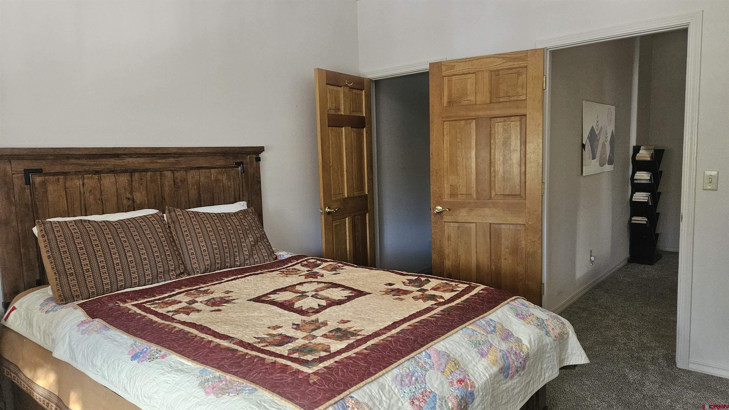 498 Woodbridge Way Durango, CO 81301 - Photo 16 of 26 a bedroom with a bed and wooden floor