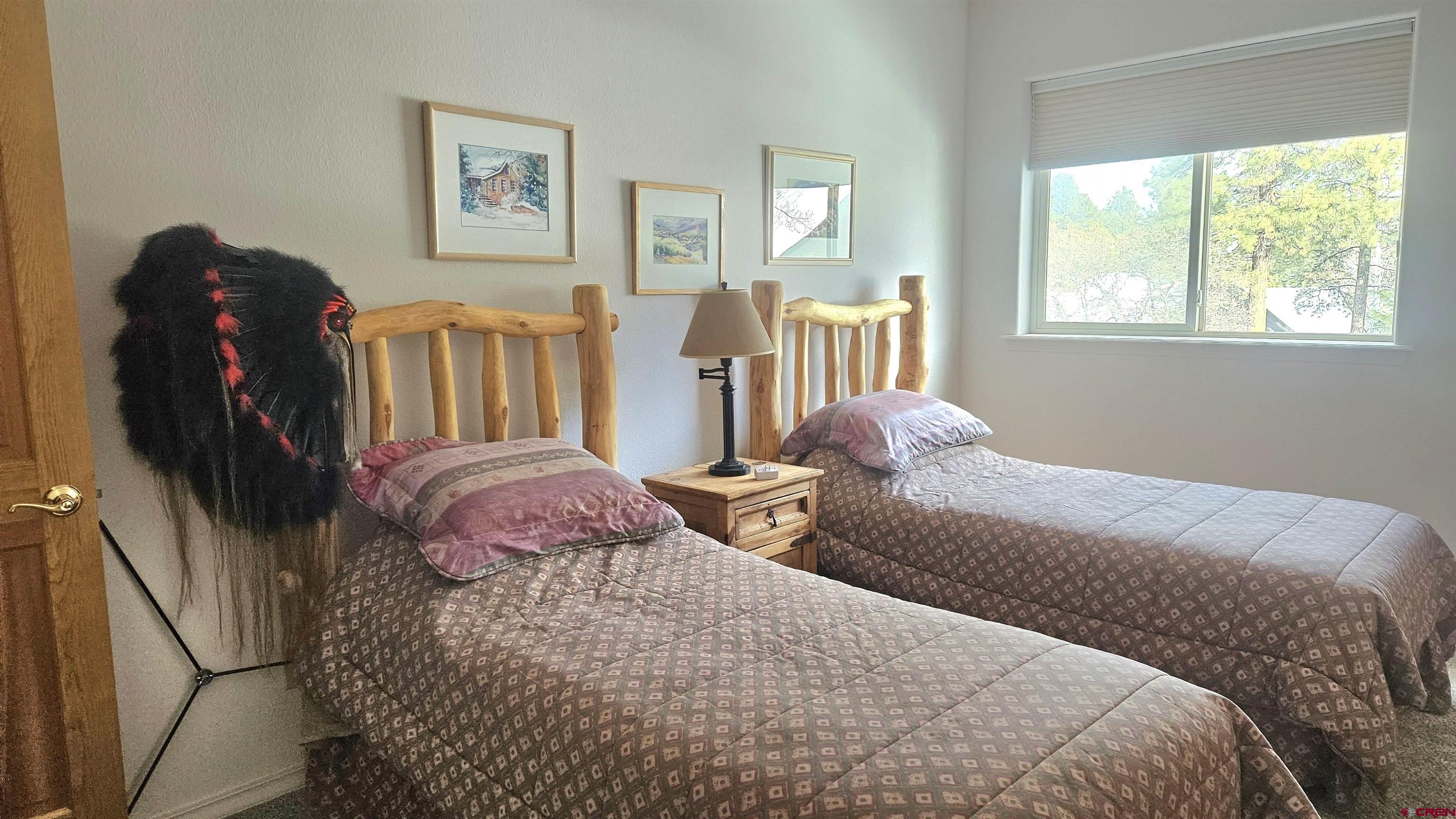 498 Woodbridge Way Durango, CO 81301 - Photo 19 of 26 a bedroom with two beds and a window