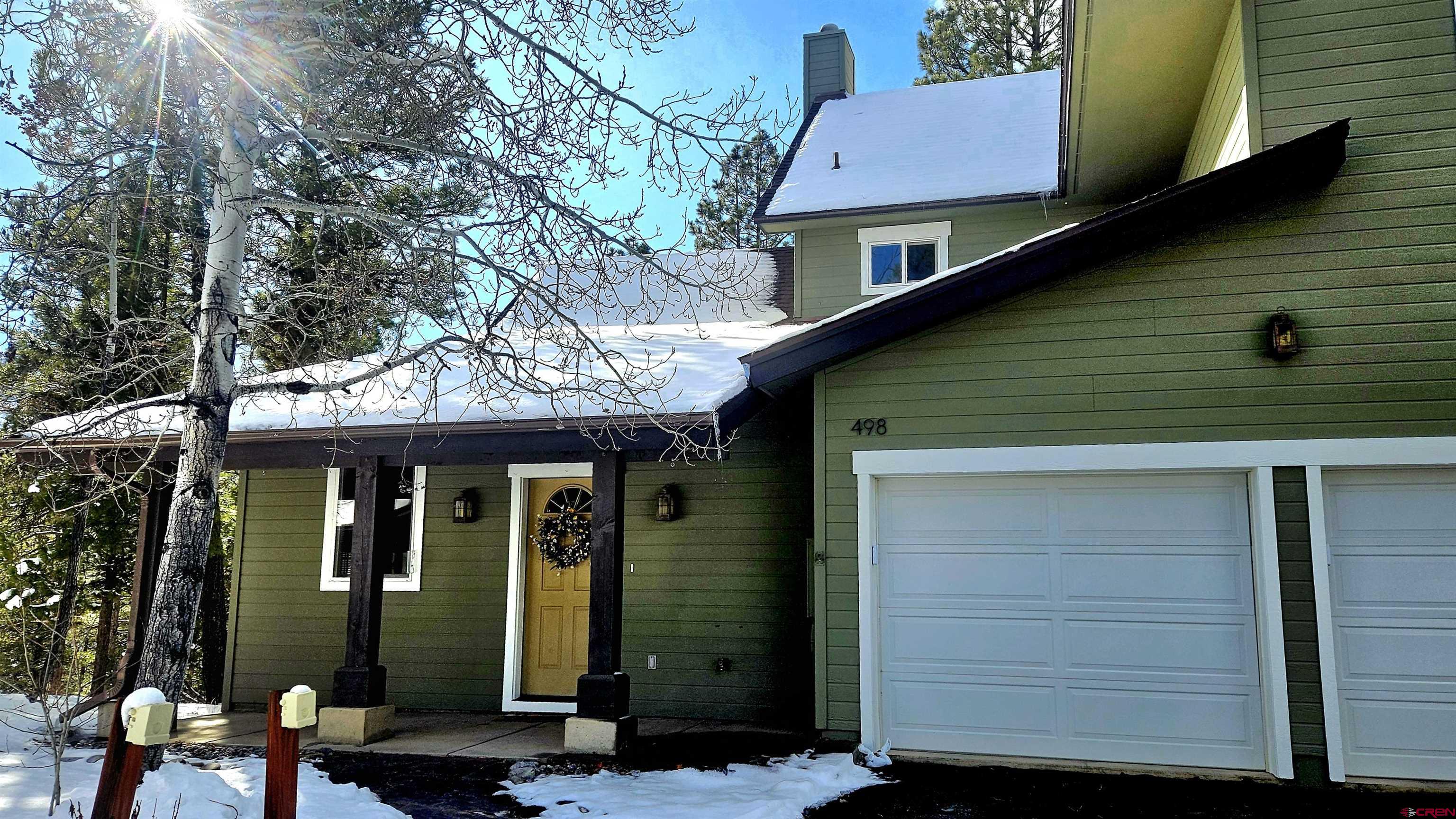 498 Woodbridge Way Durango, CO 81301 - Photo 2 of 26 a front view of a house with glass windows