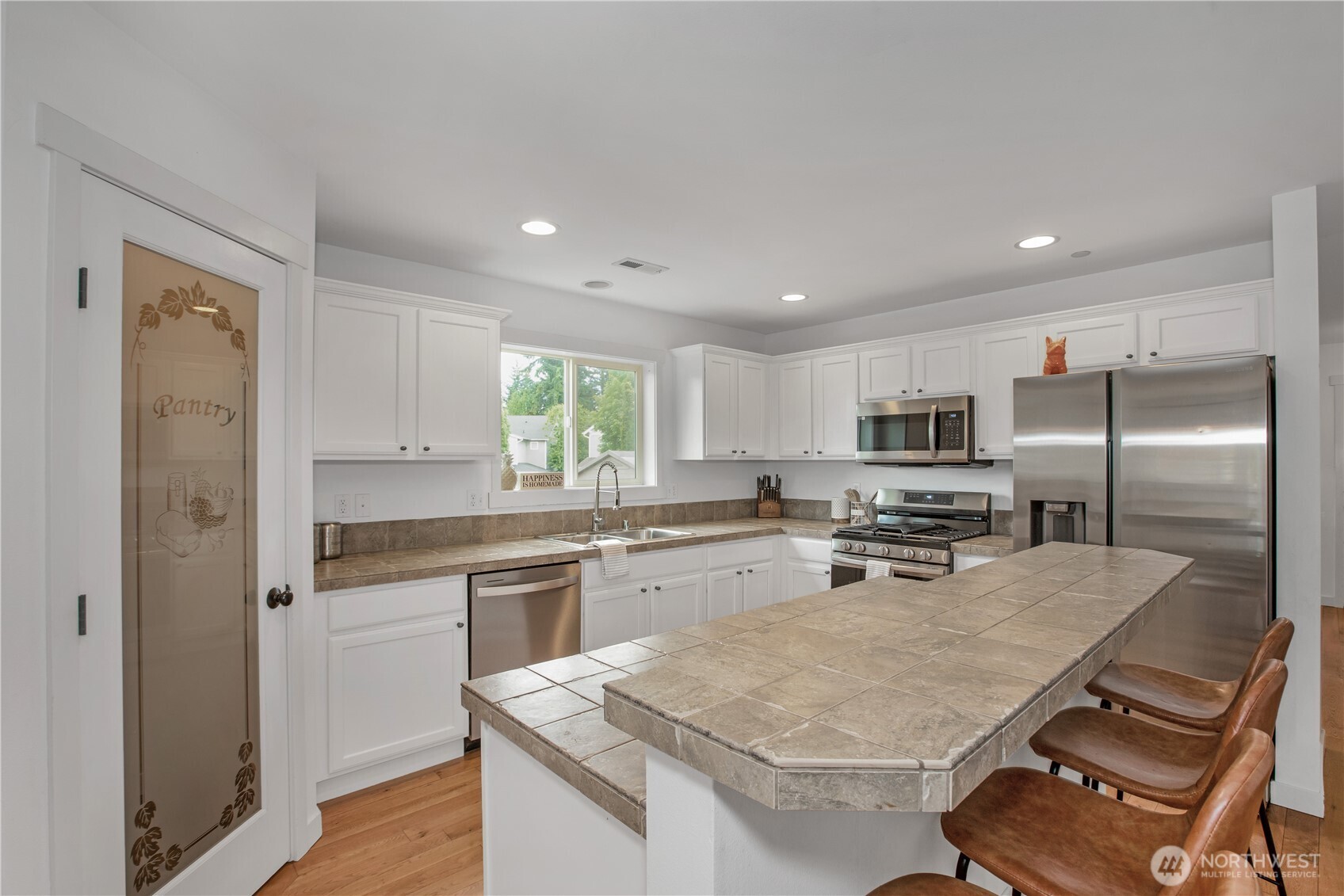 1344 Foreman Road DuPont, WA 98327 - Photo 13 of 40 a kitchen with stainless steel appliances granite countertop a stove refrigerator sink and microwave